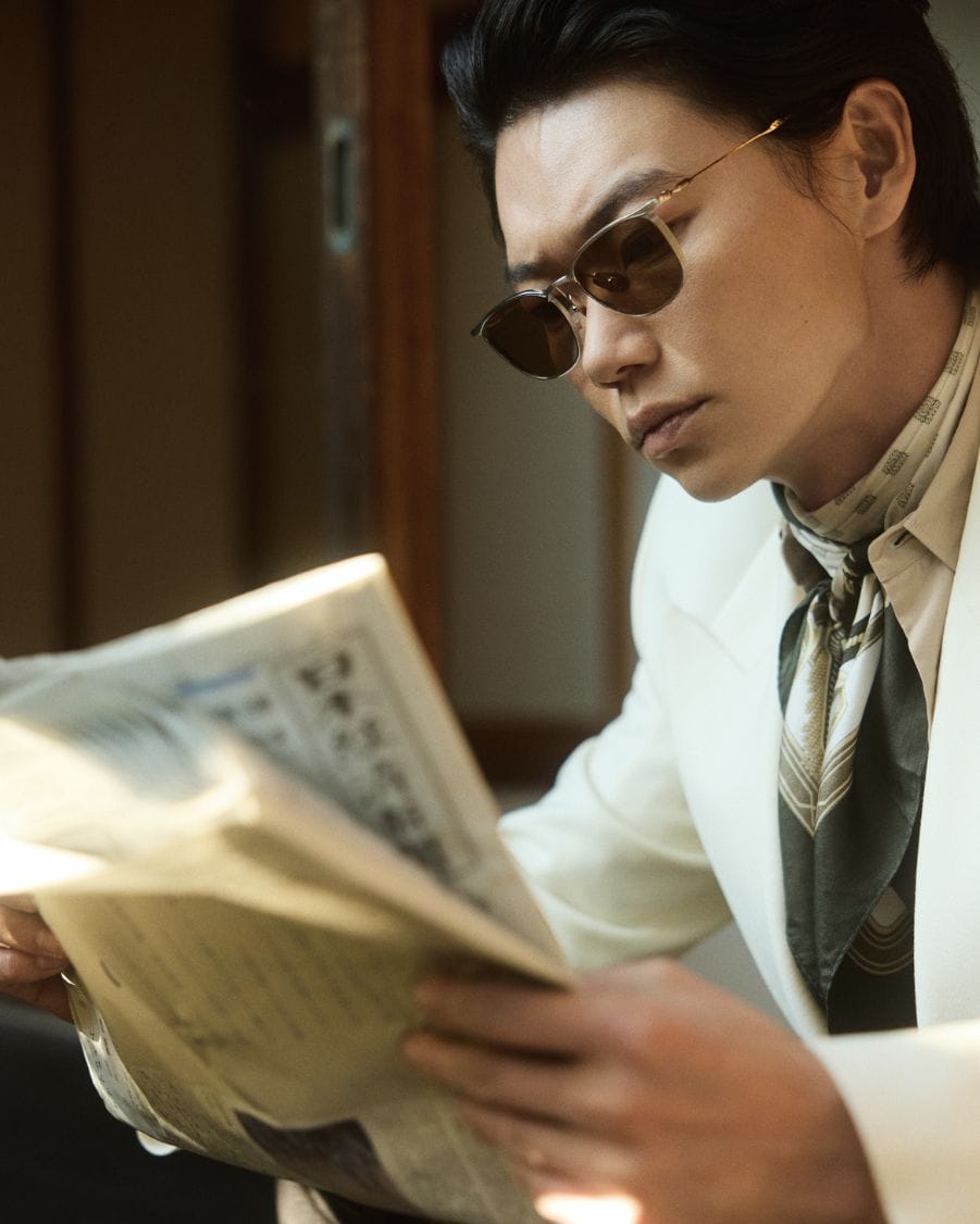 Lunetterie Generale hero image Show Kasamatsu wearing Lunetterie Generale sunglasses while reading newspaper